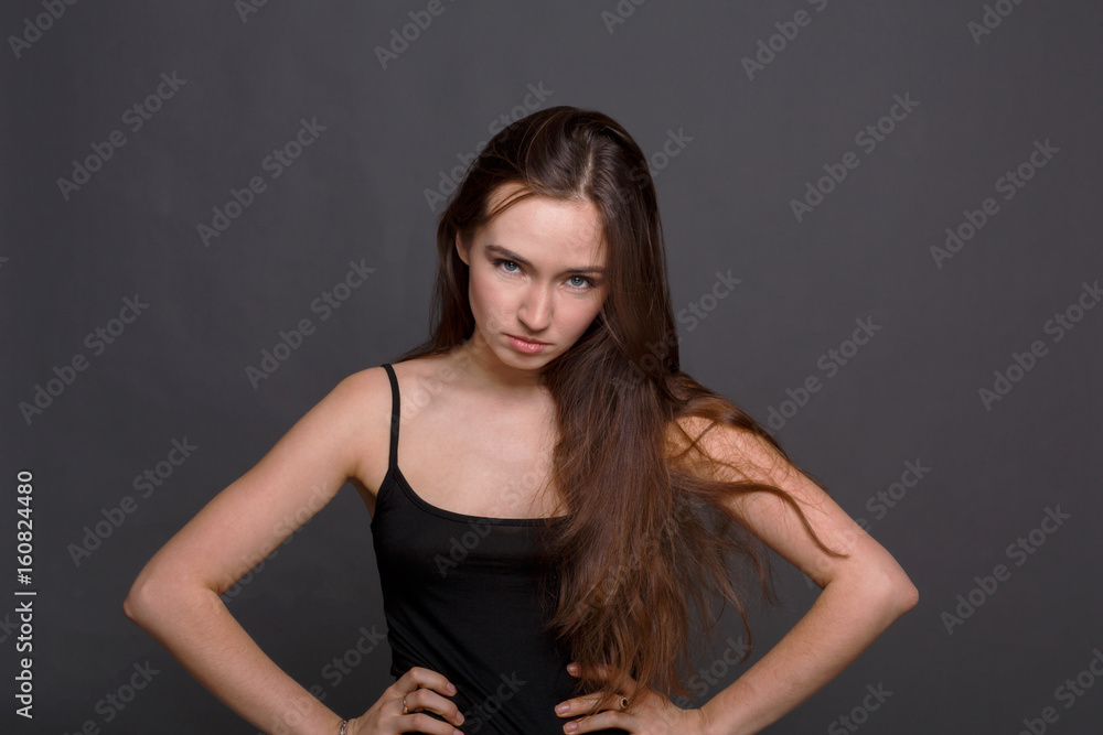 Angry woman with hands on hips looking at camera Angry woman with hands on hips looking at camera