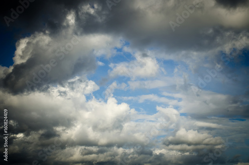 Dramatic sky. Saturated clouds before a thunderstorm, against the background of a blue sky. © Grycaj