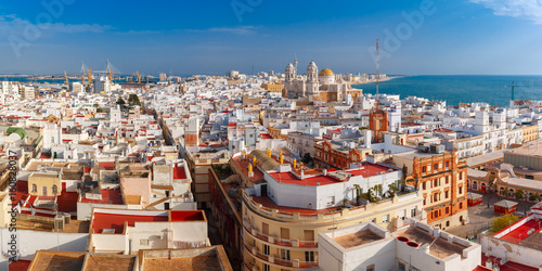 Aerial panoramic view of the old city rooftops and Cathedral de Santa Cruz in the morning from tower Tavira in Cadiz, Andalusia, Spain photo