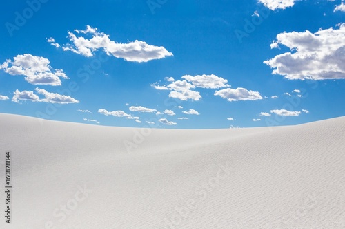white sand dunes with blue sky