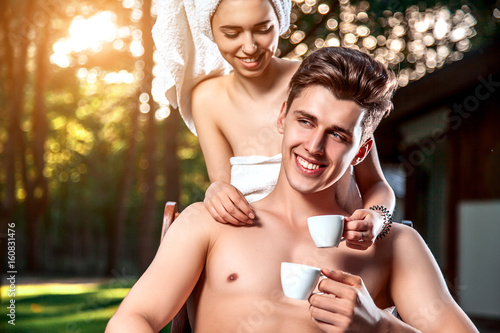 Canvas Print The guy fondly looks at his girlfriend, sitting on the bench