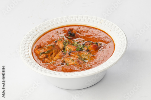 Chicken butter masala in white disposable bowl