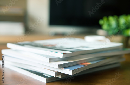 selective focus of  stacking magazine place on table in living room photo