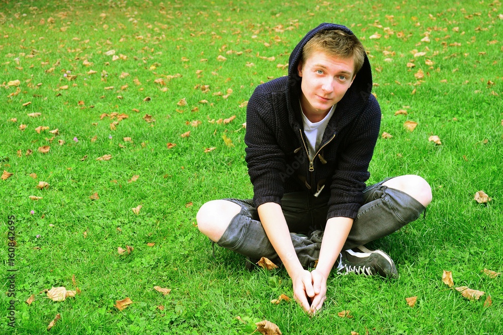 Young man in Vilnius town Bernardinu garden on autumn