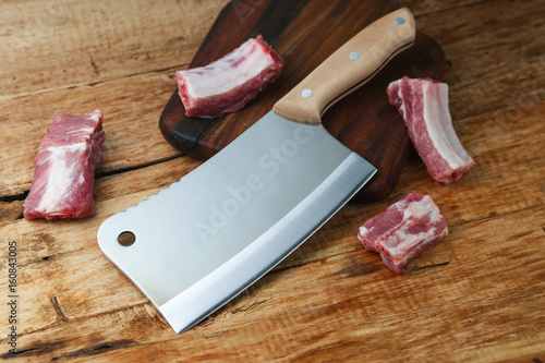 cleaver knife and ribs on wooden board