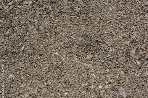 Abstract background of closeup dark uneven asphalt