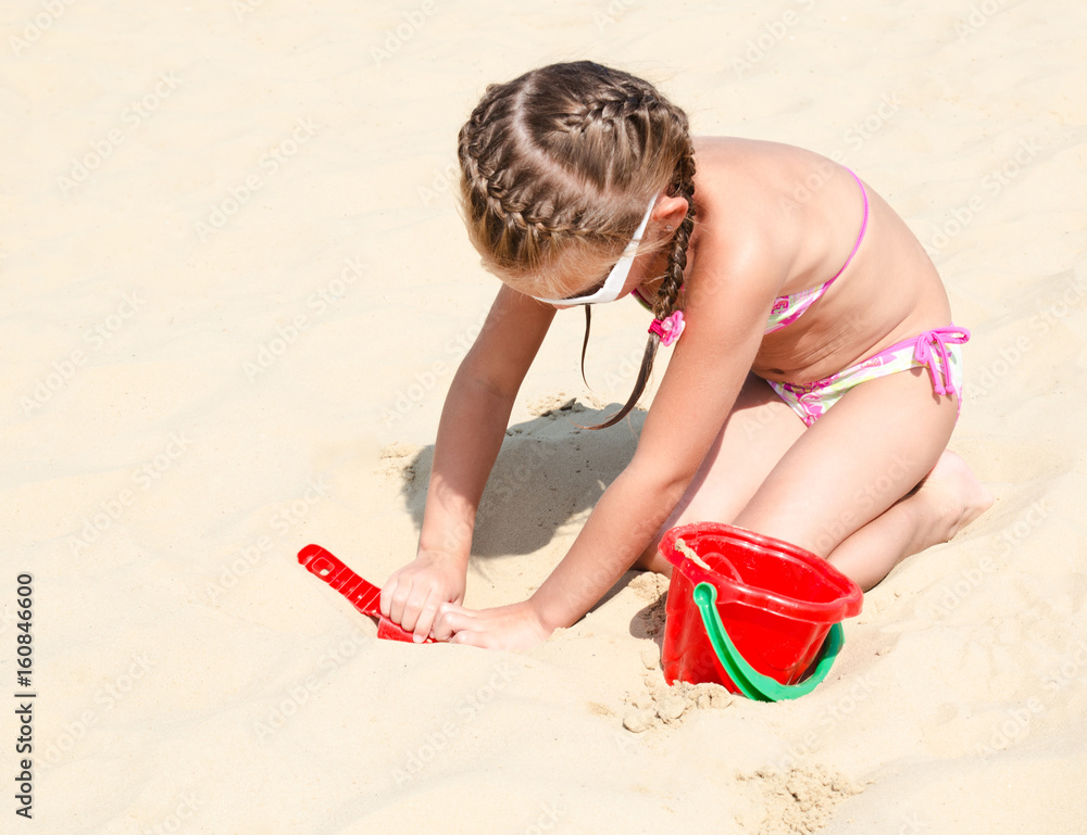 Cute smiling little girl playing on beach Cute smiling little girl playing on beach