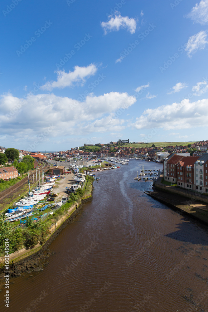 Whitby North Yorkshire England uk seaside town and tourist destination in summer with view of River Esk to Abbey and coast