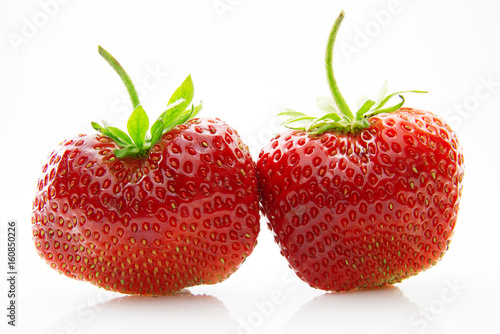 Fresh  ripe  juicy and mouth-watering strawberries with green leaves