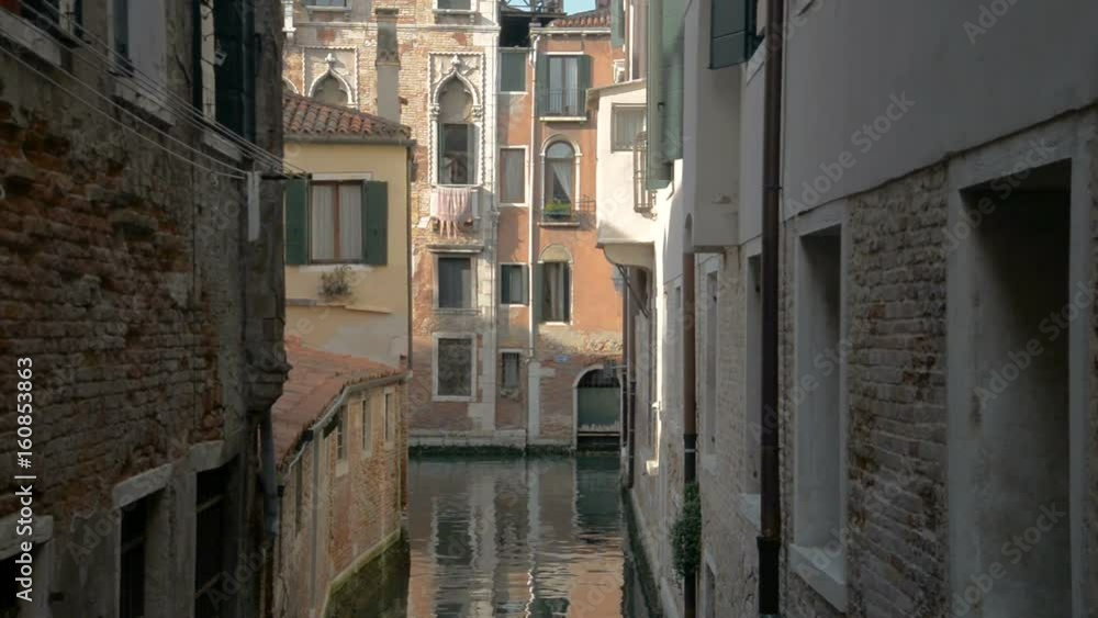 Romantic tour in gondola, rowed by a gondolier in the venice canal.