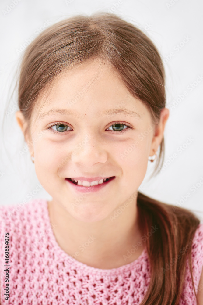 Portrait of a little girl on the white background of the wall Portrait of a little girl on the white background of the wall