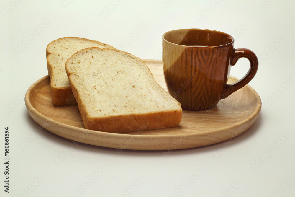 Wheat bread and cup of coffee on a white background Wheat bread and cup of coffee on a white background