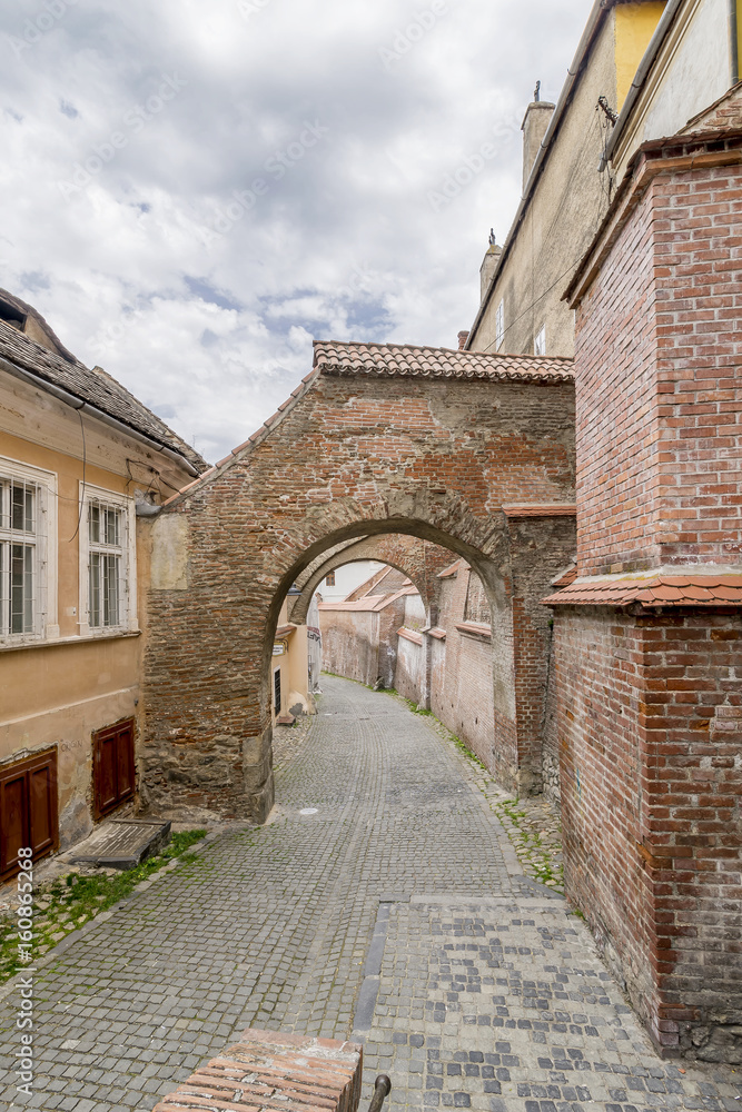 Pasajul Scarilor, ancient arch in the historic center of Sibiu, Romania, in a moment of tranquility Pasajul Scarilor, ancient arch in the historic center of Sibiu, Romania, in a moment of tranquility