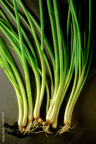 Soft light of Fresh spring onion on backboard. Vegetarian food, healthy or cooking concept