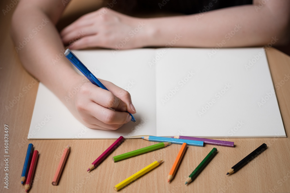 Woman hand writing on blank book Woman hand writing on blank book