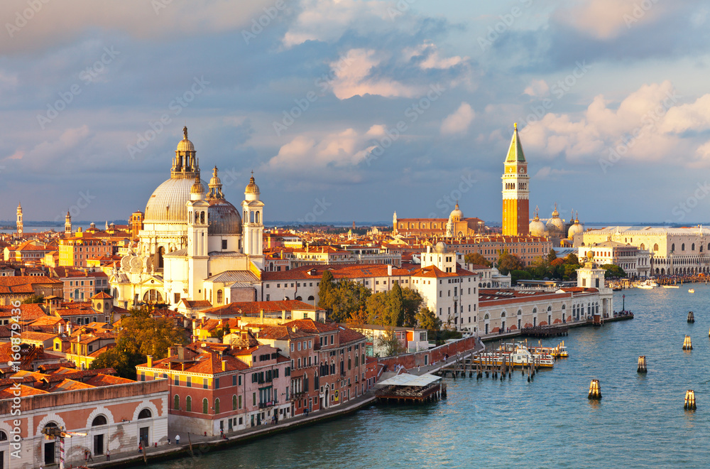 Venice. Top view of Dorsoduro district, Cathedral of Santa Maria della Salute, embankment Zattere and the Piazzetta San Marco, the Doge's Palace, Bell Tower Companile in the rays of the setting sun