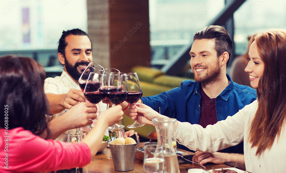 friends dining and drinking wine at restaurant