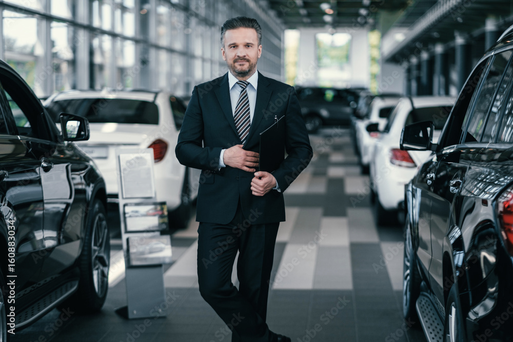 Top sales manager at dealership showroom Top sales manager at dealership showroom