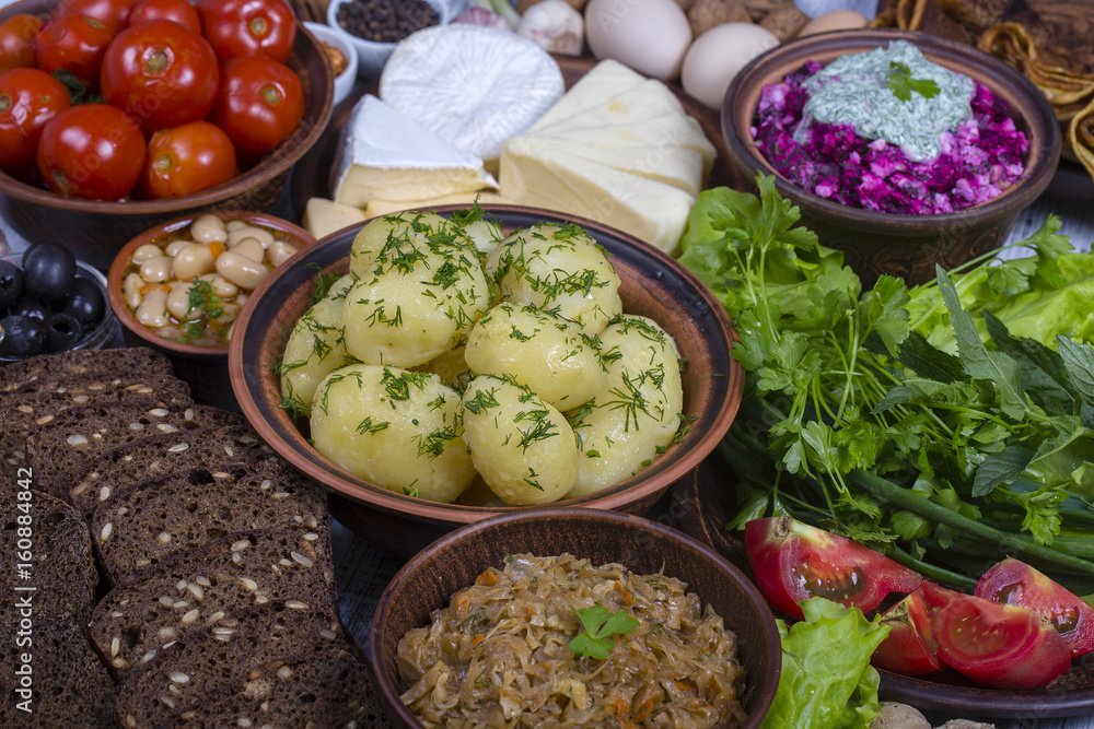 Assortment of cooked food and vegetables on the background. Top view, close up Assortment of cooked food and vegetables on the background. Top view, close up