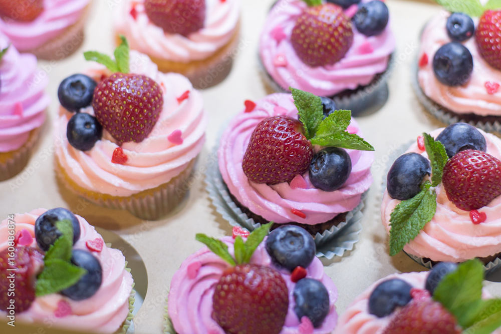 Delicious Cupcake with berries in box Delicious Cupcake with berries in box