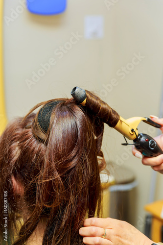 beauty, hairstyle, blow-dry and people concept - close up of young woman and hairdresser