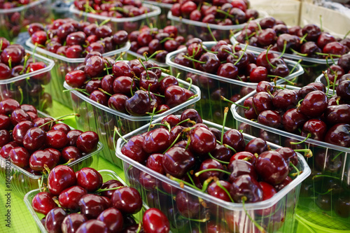 cherries in baskets on farmer's market stand