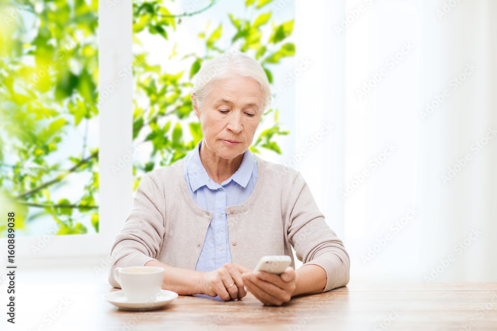 senior woman with smartphone texting at home senior woman with smartphone texting at home