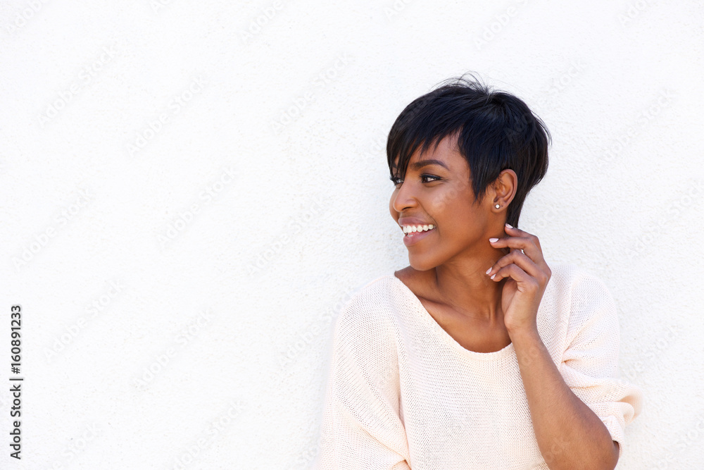 Beautiful young african woman smiling by white background Beautiful young african woman smiling by white background