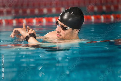 Male swimmer checking his watch