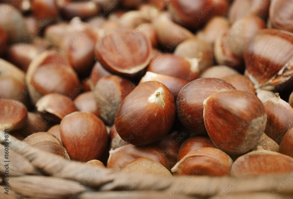 Basket of fresh harvested sweet or Spanish chestnuts, selective focus Basket of fresh harvested sweet or Spanish chestnuts, selective focus