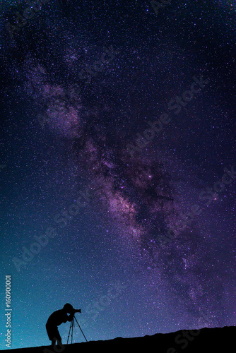 Landscape with Milky way galaxy. Night sky with stars and silhouette Photographer take photo on the mountain.