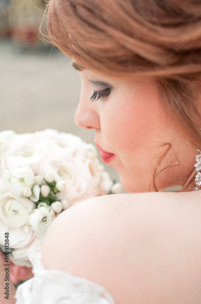 Wedding background. Beautiful profile of the bride with a bouquet. The concept of the beginning of family life, marriage. Lace wedding dress. Wedding background. Beautiful profile of the bride with a bouquet. The concept of the beginning of family life, marriage. Lace wedding dress.