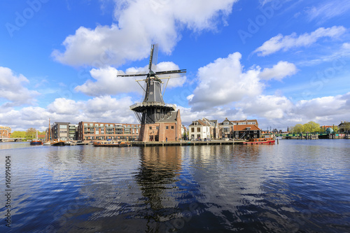 View of Windmill De Adriaan reflected in the canal of the river Spaarne Haarlem North Holland The Netherlands Europe