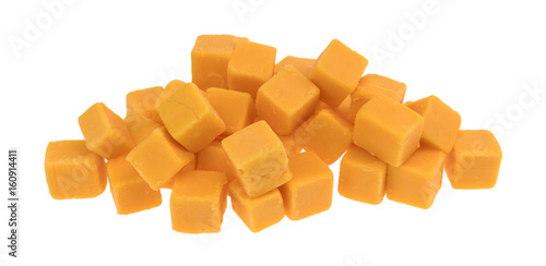 Cubed mild cheddar cheese in a pile isolated on a white background.