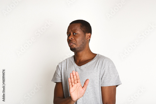 Negative human emotion, black man expressing protest photo