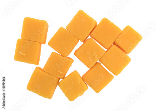 Top view of several cubes of mild cheddar cheese isolated on a white background.