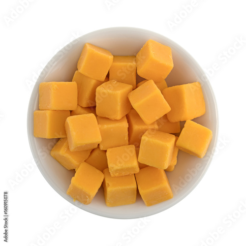 Cubed mild cheddar cheese in a white bowl.