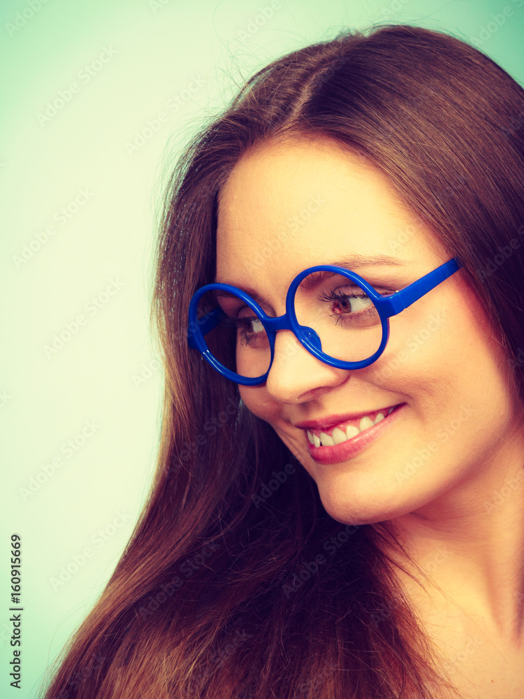 Fototapeta premium Happy smiling nerdy woman in weird glasses