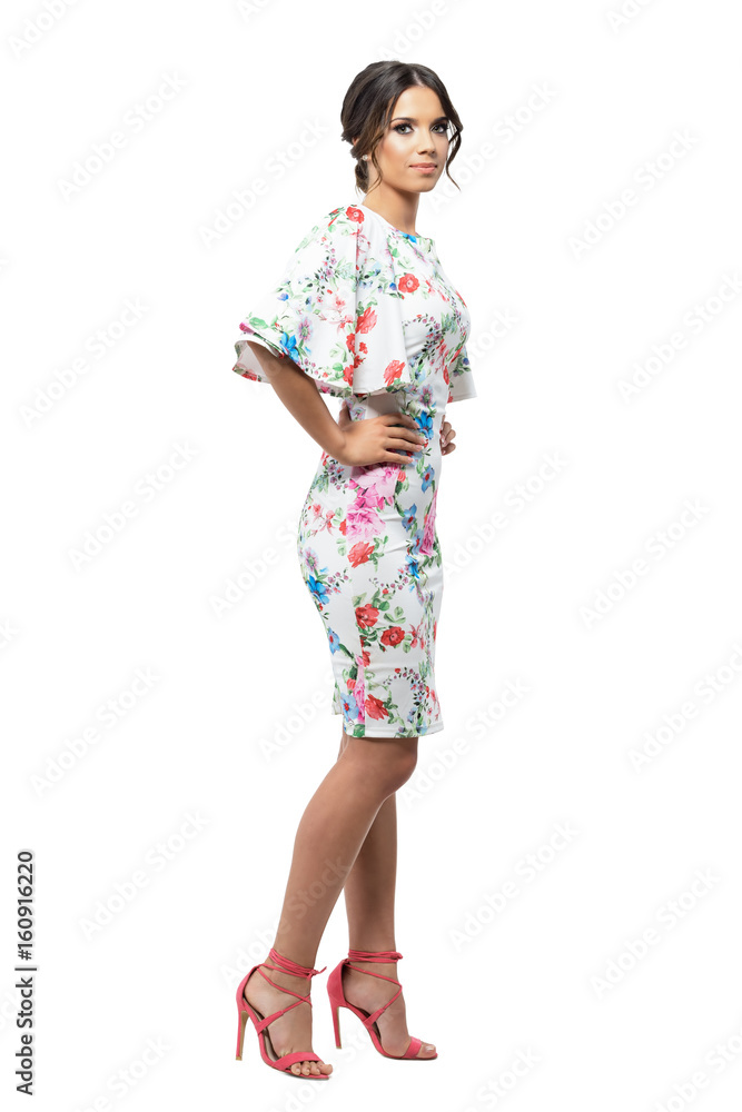 Gorgeous tanned hispanic woman posing with hands on hips. Side view. Full body length portrait isolated on white background. Gorgeous tanned hispanic woman posing with hands on hips. Side view. Full body length portrait isolated on white background.
