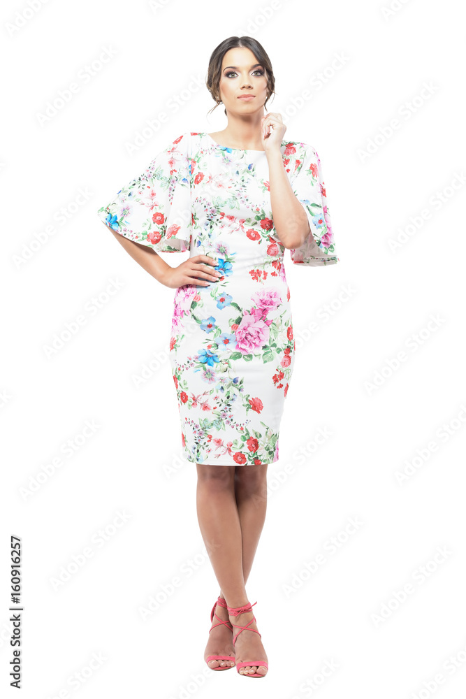 High key portrait of young pretty woman in evening dress with floral pattern posing. Full body length portrait isolated on white background. High key portrait of young pretty woman in evening dress with floral pattern posing. Full body length portrait isolated on white background.