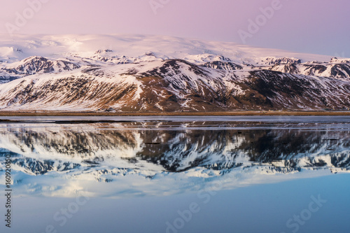 Dyrholavegur, Vik i Myrdal, Southern Iceland, Iceland. Mountains and Vatnajokull glacier reflected in the waters. photo