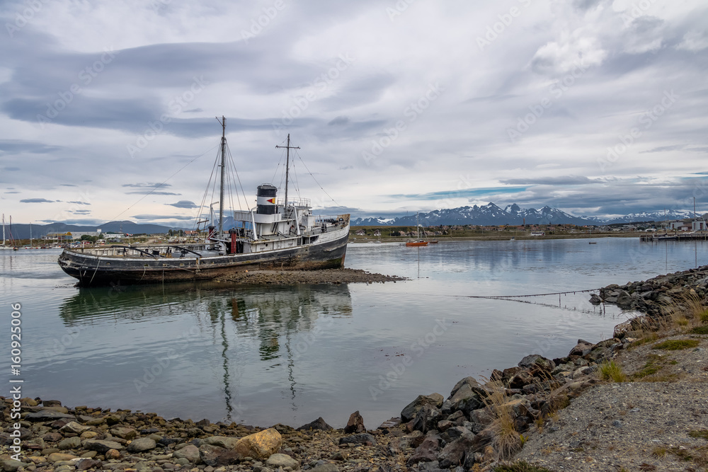 Fototapeta premium Abandoned HMS Justice tug boat grounded in Patagonia - Ushuaia, Tierra del Fuego, Argentina