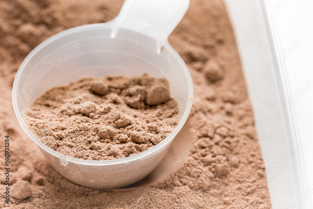nutrition for workout with protein cocktail powder on white background close up nutrition for workout with protein cocktail powder on white background close up