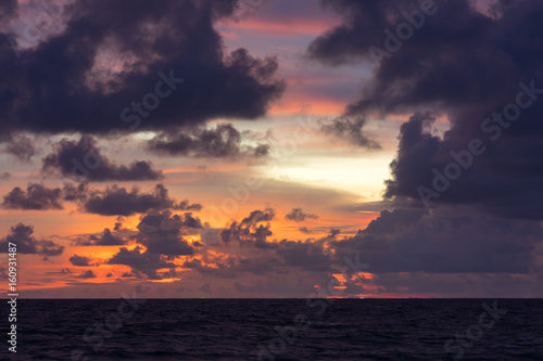 Dark pink sunset in clouds over the sea