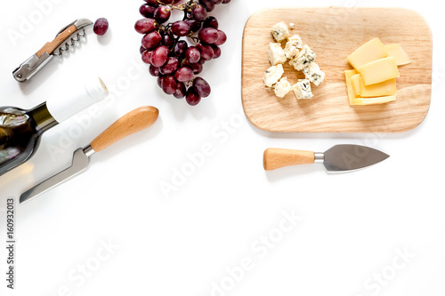 Obraz na plátně Bottle of red wine with cheese and grape aperitive on white background space for