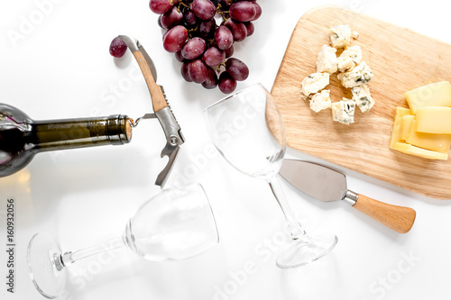 Fototapeta Bottle of red wine and wine glasses with cheese and grape aperitive on white bac