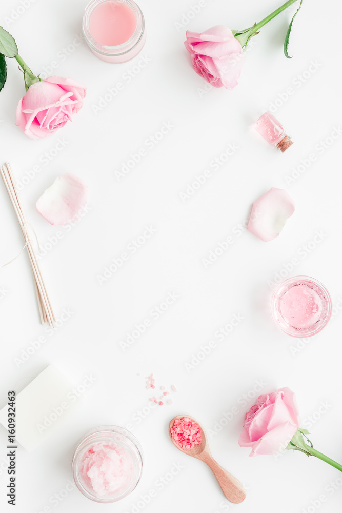 cosmetic set with rose blossom and body cream on white desk background top view mock-up cosmetic set with rose blossom and body cream on white desk background top view mock-up