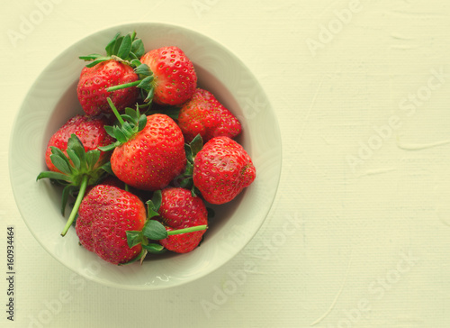 Fresh ripe strawberries in bowl on white background, copy space