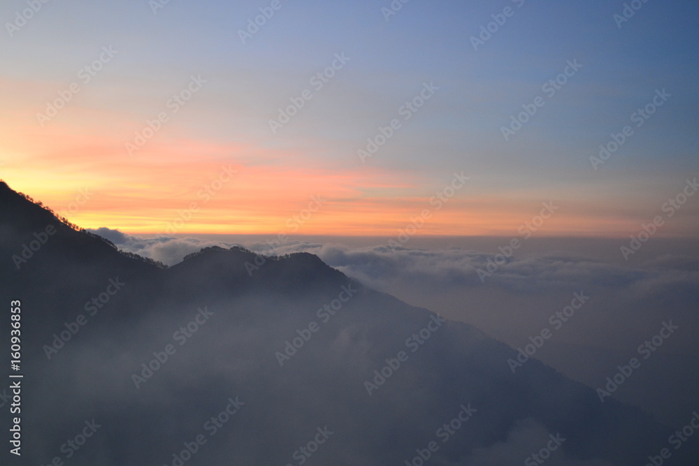 sunset over the clouds in mountain