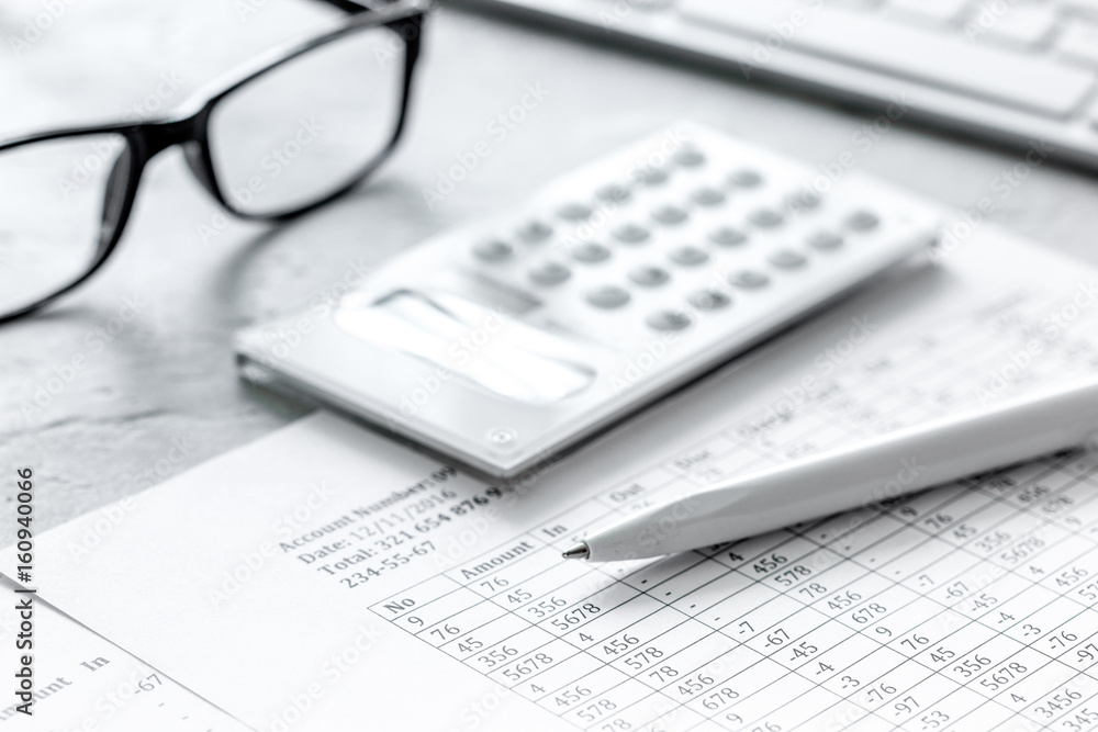 taxes accounting with calculator in office work space on stone desk background top view taxes accounting with calculator in office work space on stone desk background top view